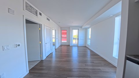 A long hallway with a red sign that says "NO PARKING" on the wall.