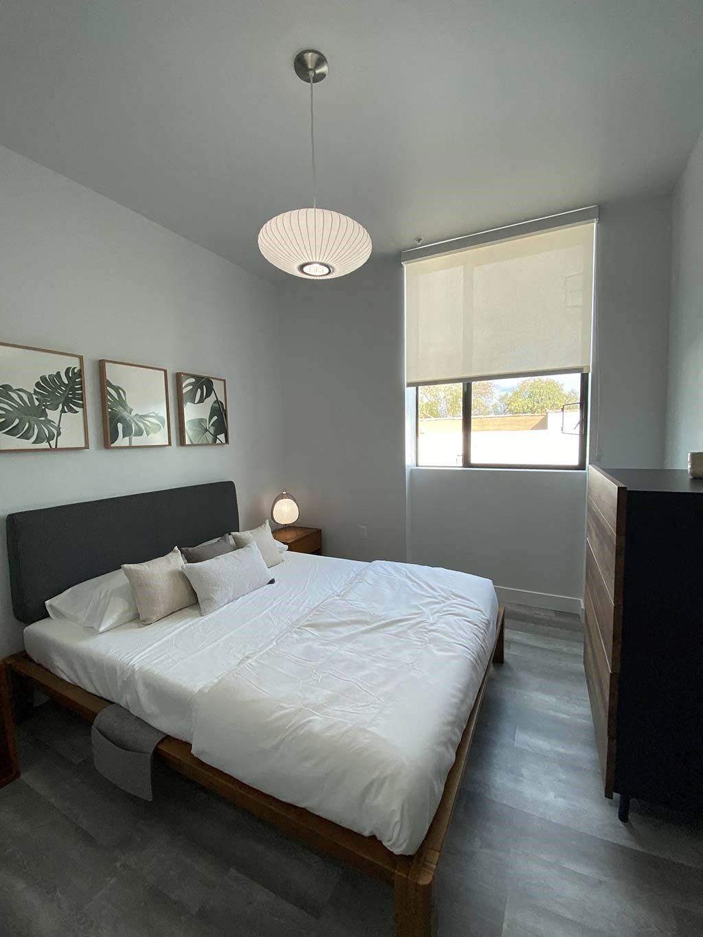 a bedroom with a white bed and a window