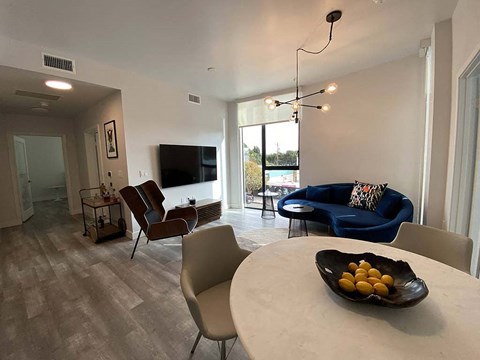 a living room with a table with a bowl of fruit on it