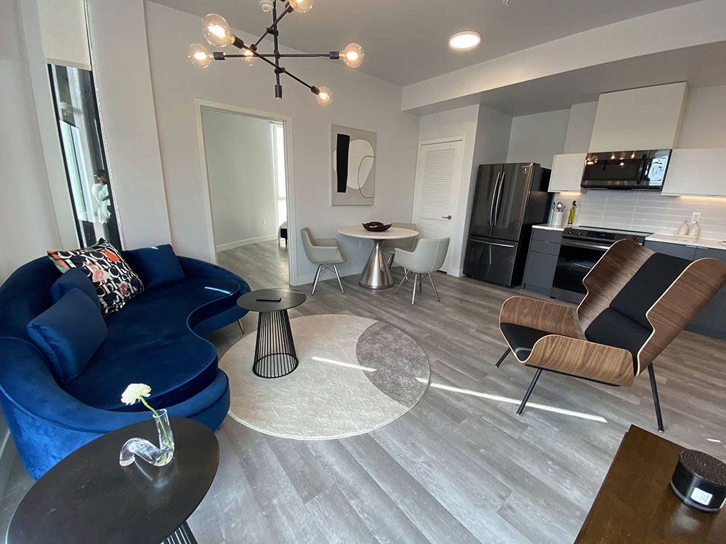 a living room with a blue couch and a table
