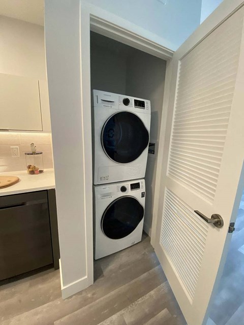 a front loading washer and dryer in a closet
