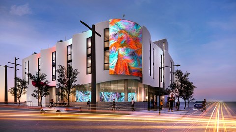a rendering of a building with a colorful facade on a city street