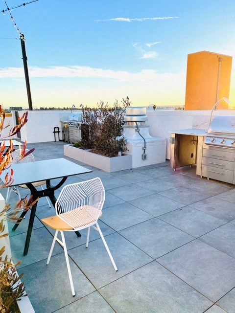 a terrace with a table and chairs on a roof