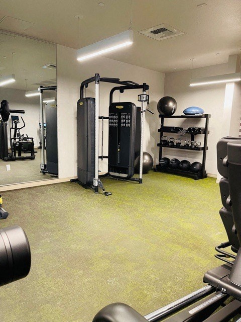a gym with weights and other equipment in a room