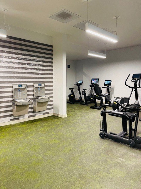 a gym with several exercise bikes and two urinals