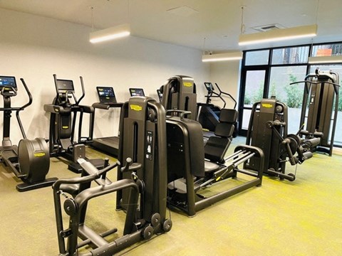 a gym with various exercise equipment in a building