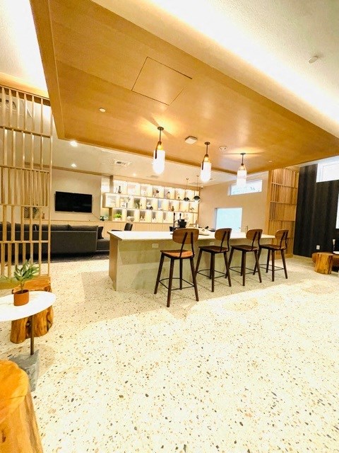 a large room with a kitchen and a dining table