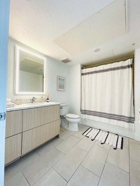 a bathroom with a toilet and a sink and a mirror