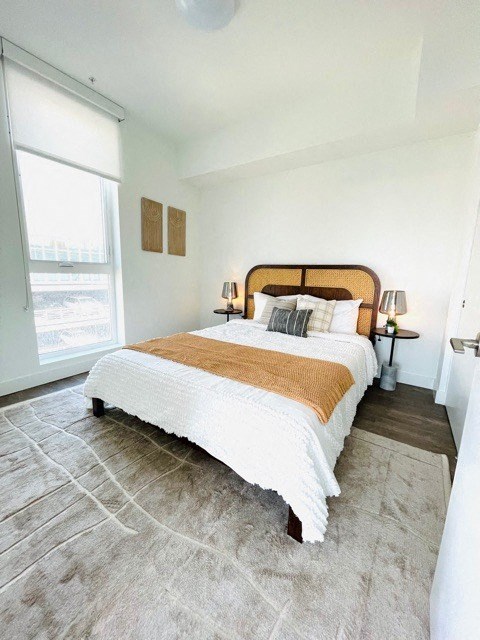 a bedroom with a bed and a window