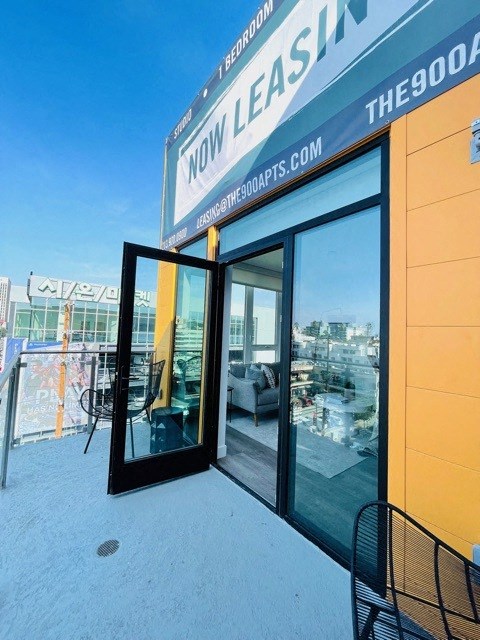 a glass door on a building with a view of a balcony
