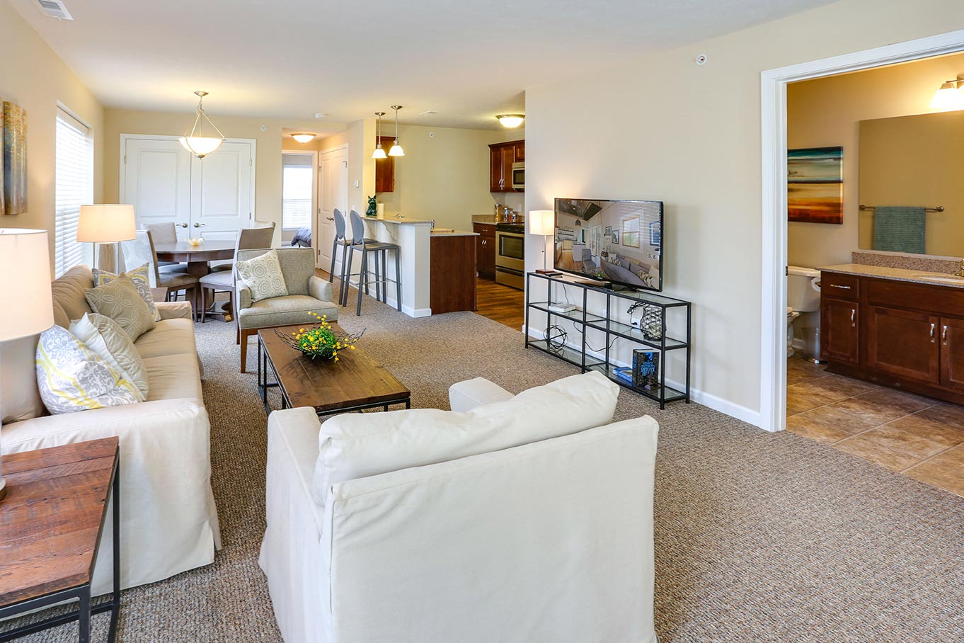 A living room with a white couch and a coffee table.
