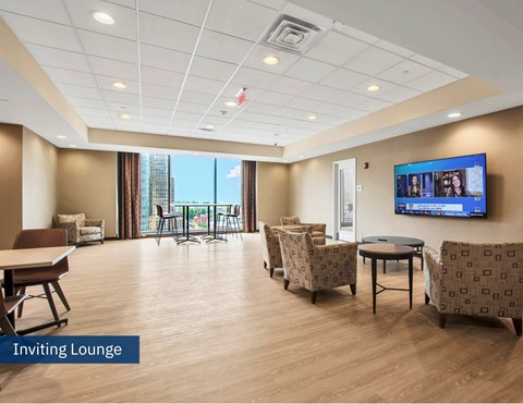 A spacious lounge area with a flat screen TV mounted on the wall.