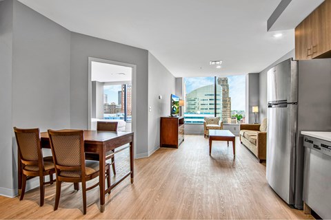 A modern kitchen with a dining table and chairs.