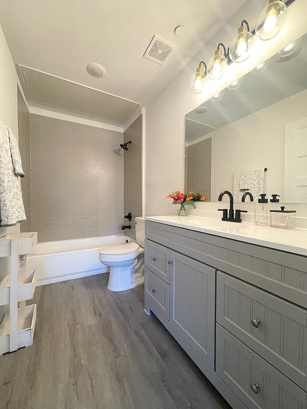 a white bathroom with a toilet and a sink