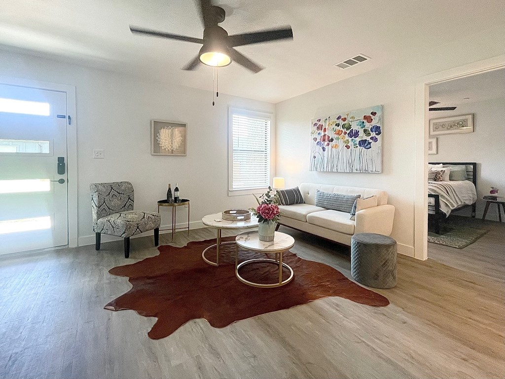 a living room with a couch and a ceiling fan
