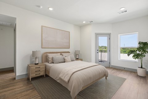 A bedroom with a large bed, a nightstand with a lamp, and a painting on the wall.