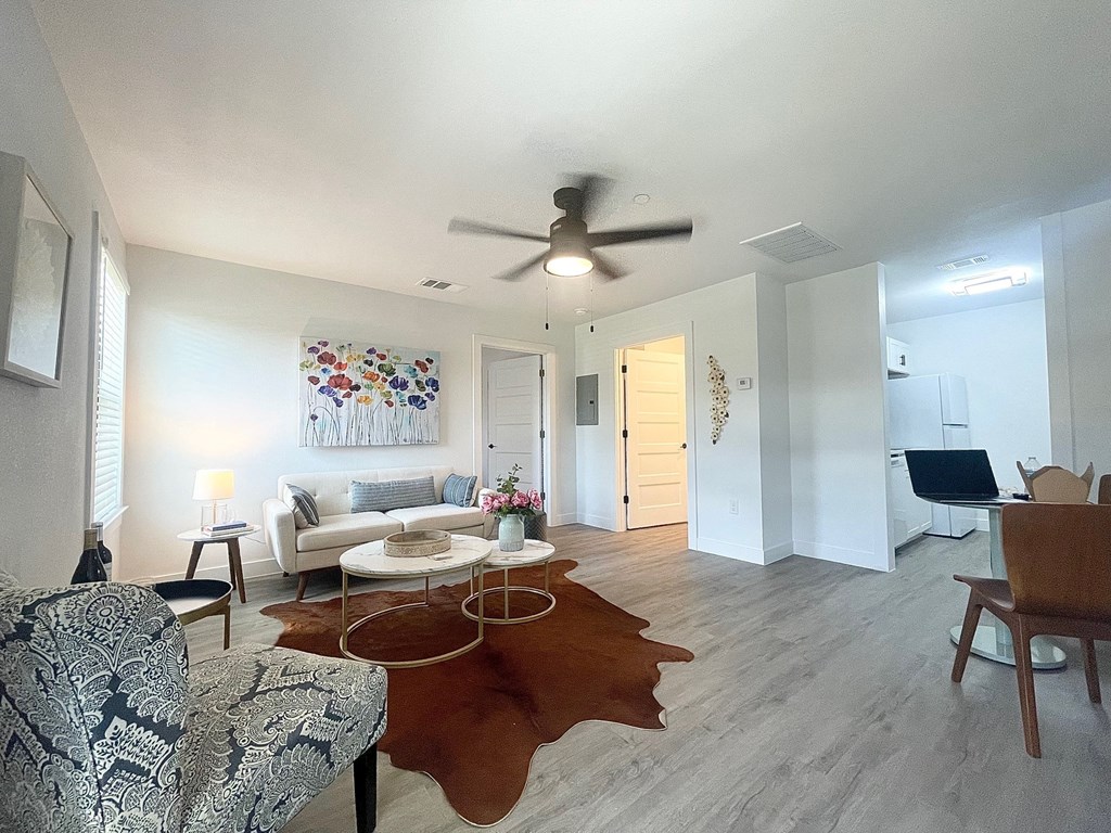 a living room with a ceiling fan and a couch