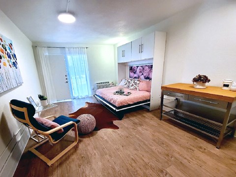 a bedroom with a bed and a desk in a small room