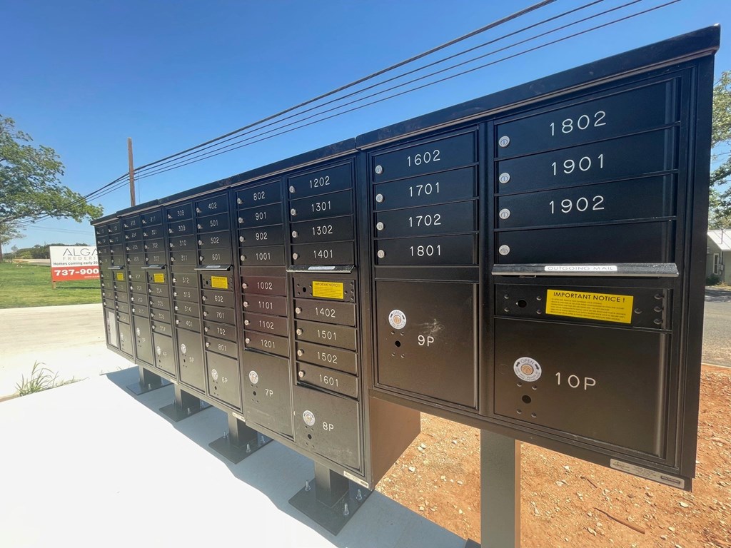 a bunch of metal mailboxes sitting on a sidewalk