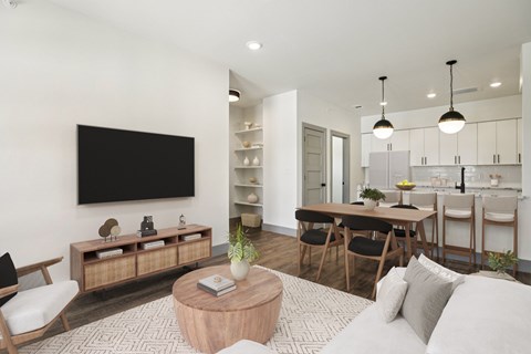 A modern living room with a flat screen TV mounted on the wall.