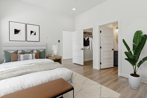 A bedroom with a large bed and a bench in the foreground.