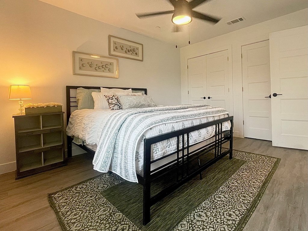 a bedroom with a bed and a ceiling fan