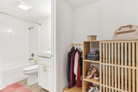 a bathroom with a crib and a toilet and a shower