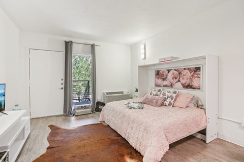 a bedroom with a bed and a dresser and a window