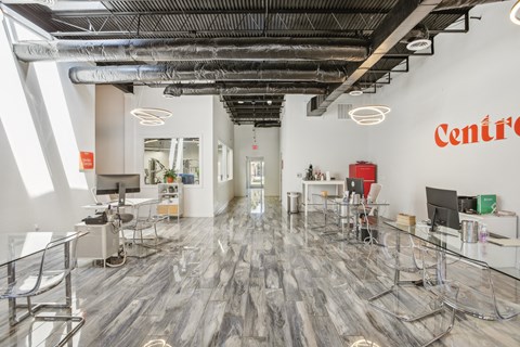 a large room with tables and chairs and a ceiling with the wordcentrism