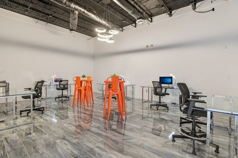 a large room with desks and chairs and a tv