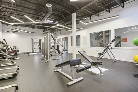 a gym with weights and other exercise equipment in a building