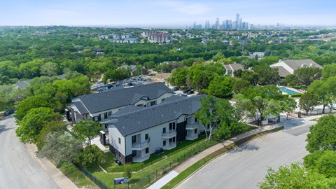 A bird's eye view of a residential area with houses and trees.