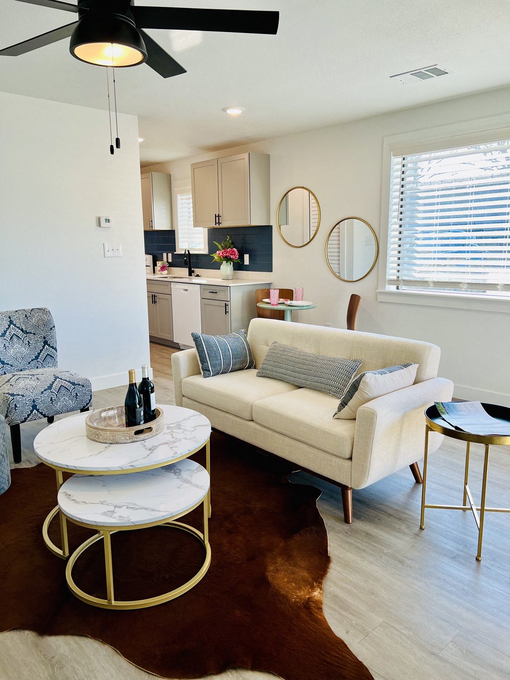 a living room with a couch and a table and a kitchen