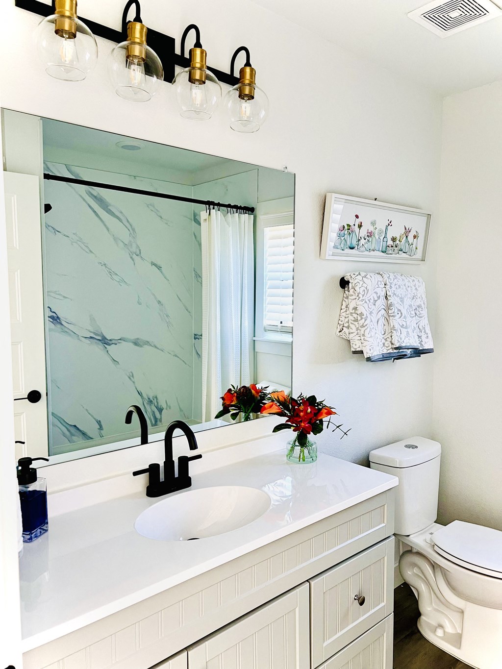 a bathroom with a sink and a mirror and a toilet