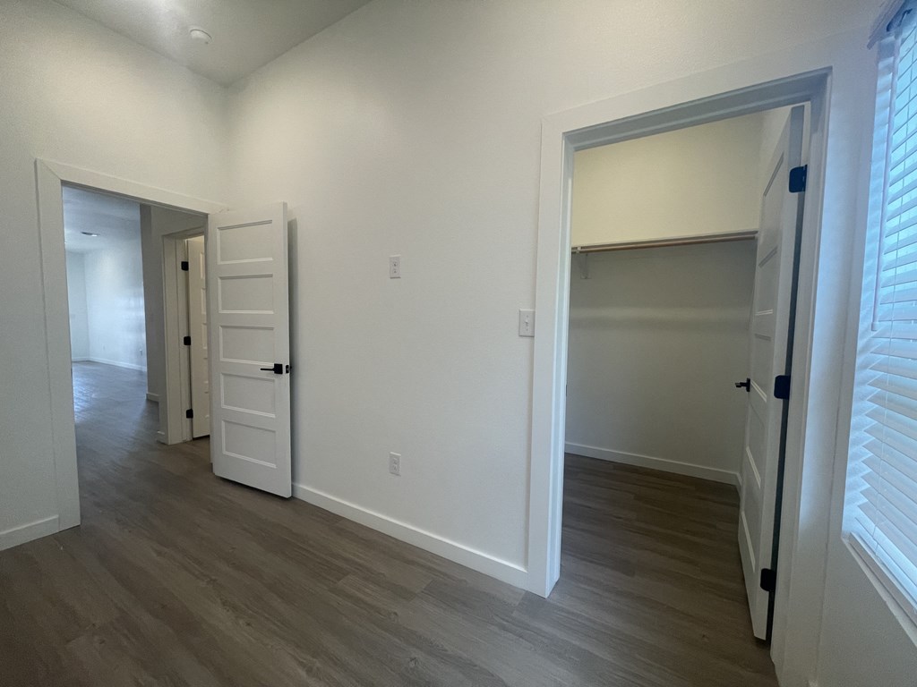 a bedroom with a closet and an open door