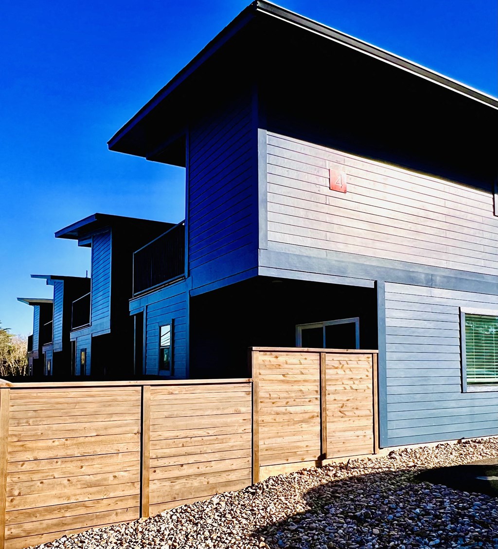 a row of houses with a wooden fence