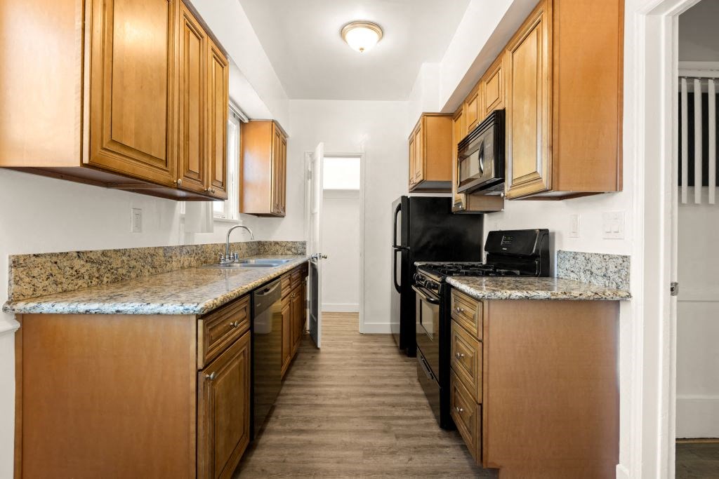 a kitchen with wood cabinets and granite counter tops