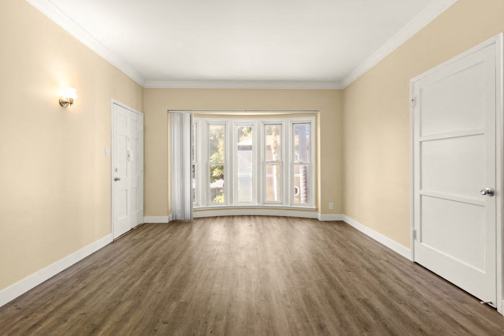 a living room with a large window and a door