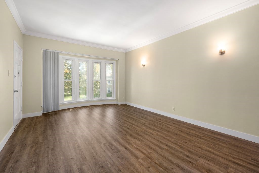 an empty living room with a large window