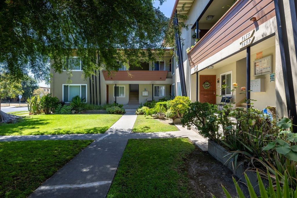 A residential area with a house and a walkway.