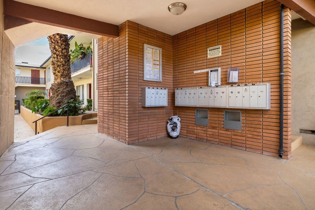 the lobby or reception area of a building with a urinal and a palm tree