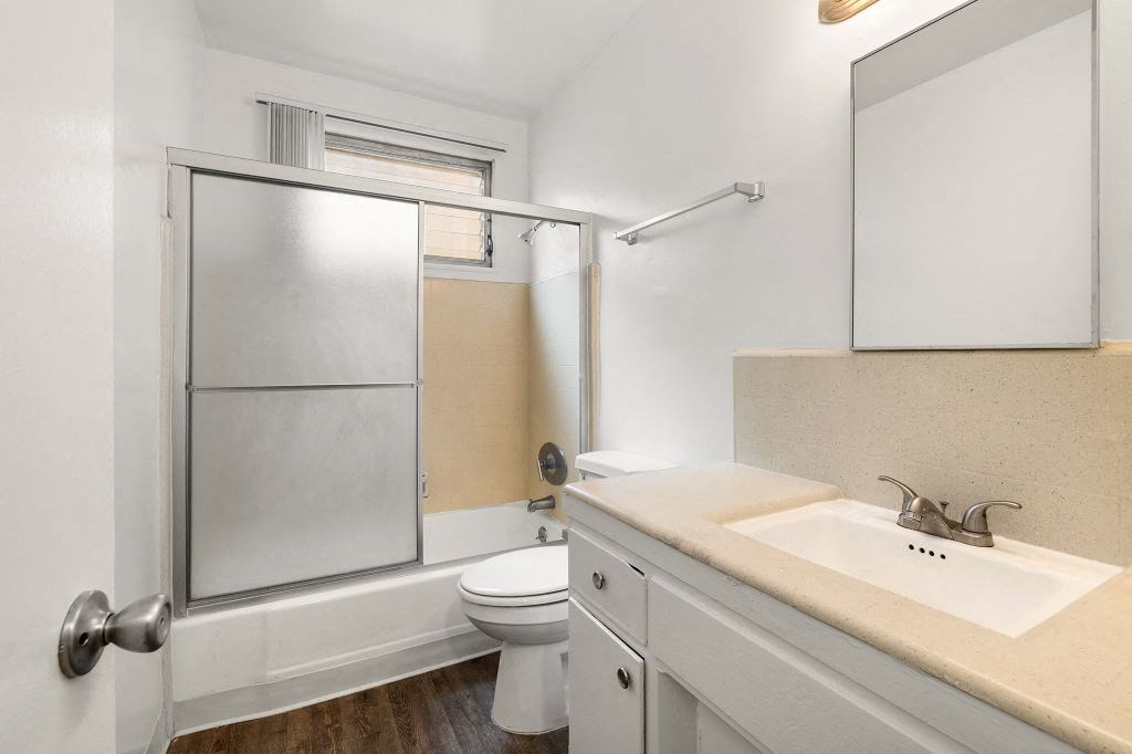 a bathroom with a sink toilet and shower