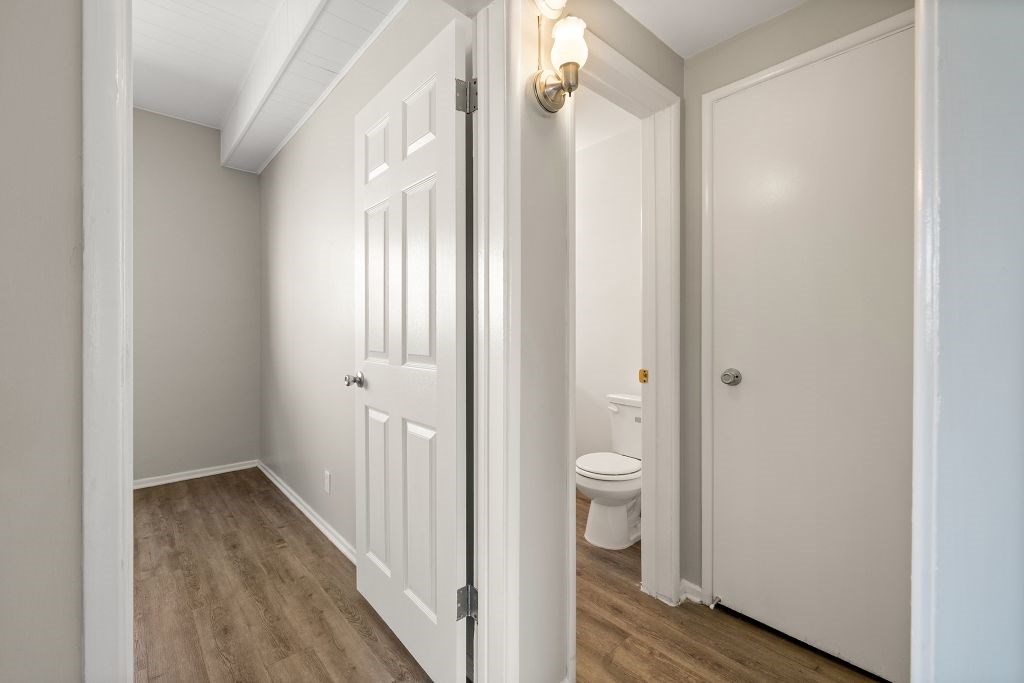 A white door is open to a bathroom.
