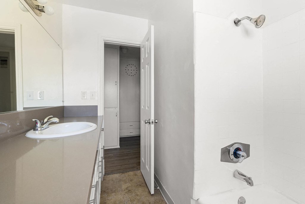 a bathroom with a sink and a door to a hallway