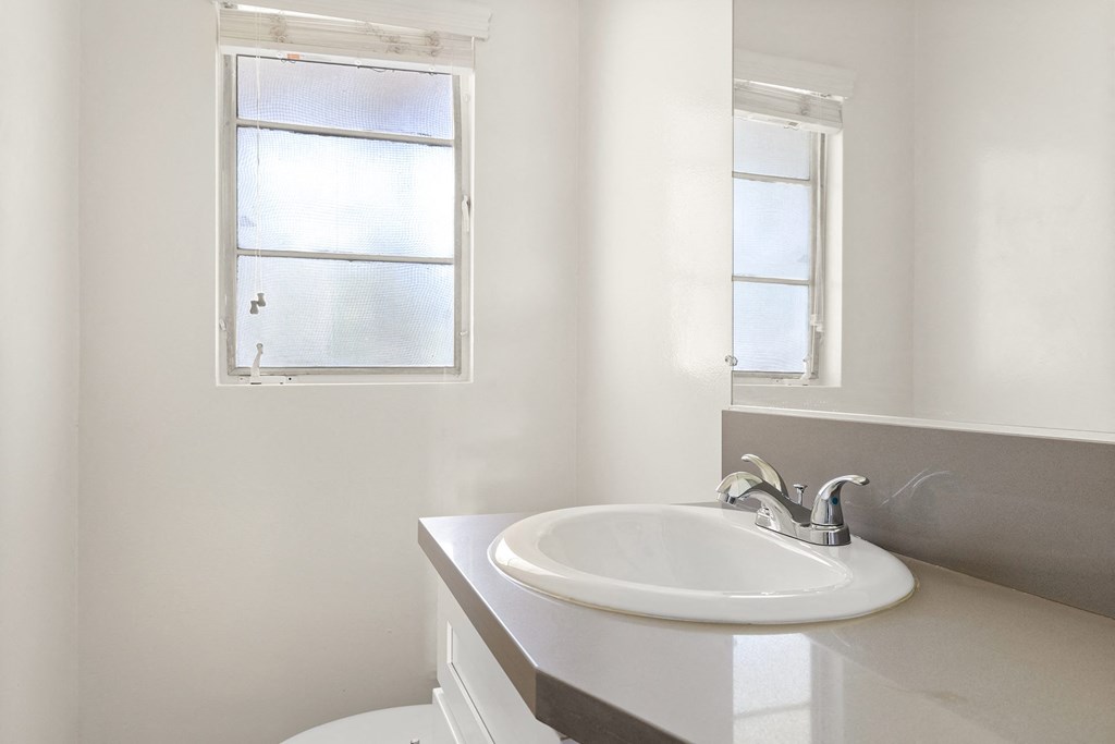 a small bathroom with a sink and a window