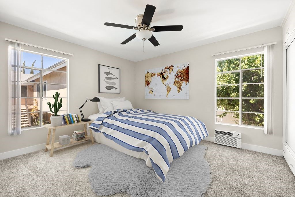 A bedroom with a large bed and a world map on the wall.