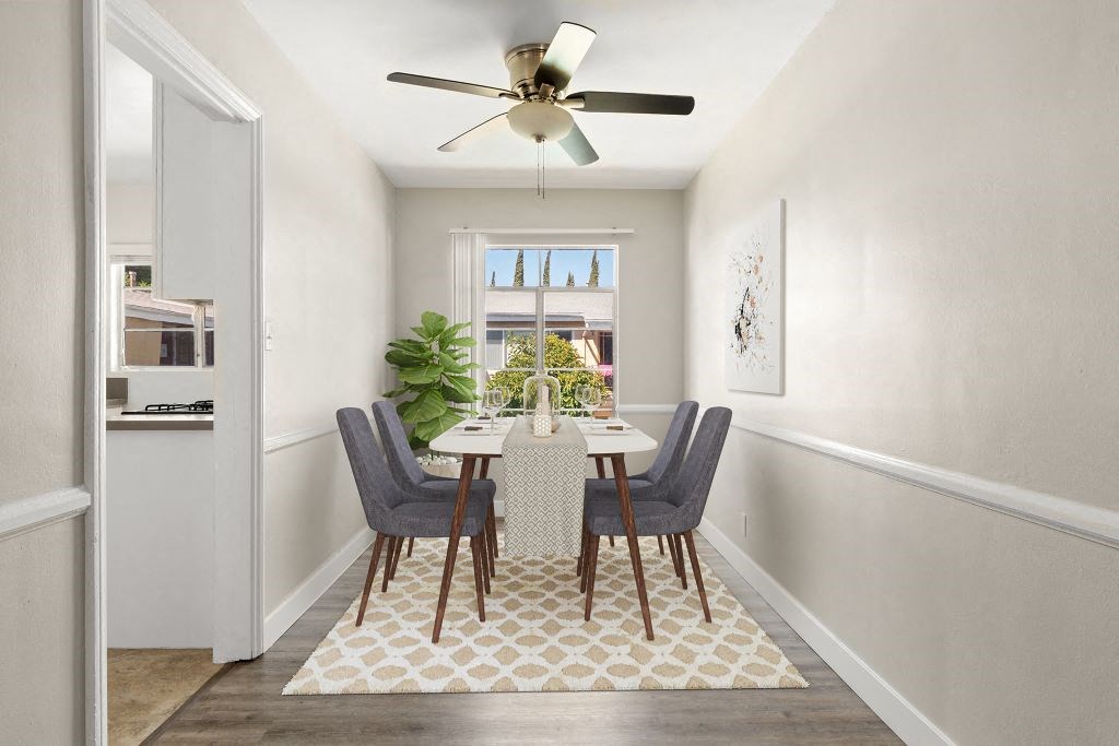 A dining room with a table and chairs.
