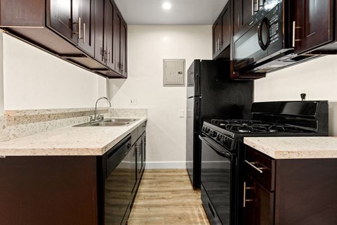a kitchen with a stove refrigerator and sink