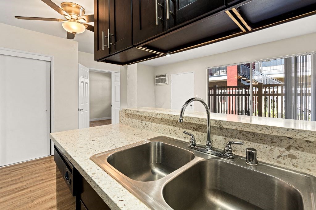 a kitchen with a sink and a window at Riverside Villas Apartments, Valley Village, California