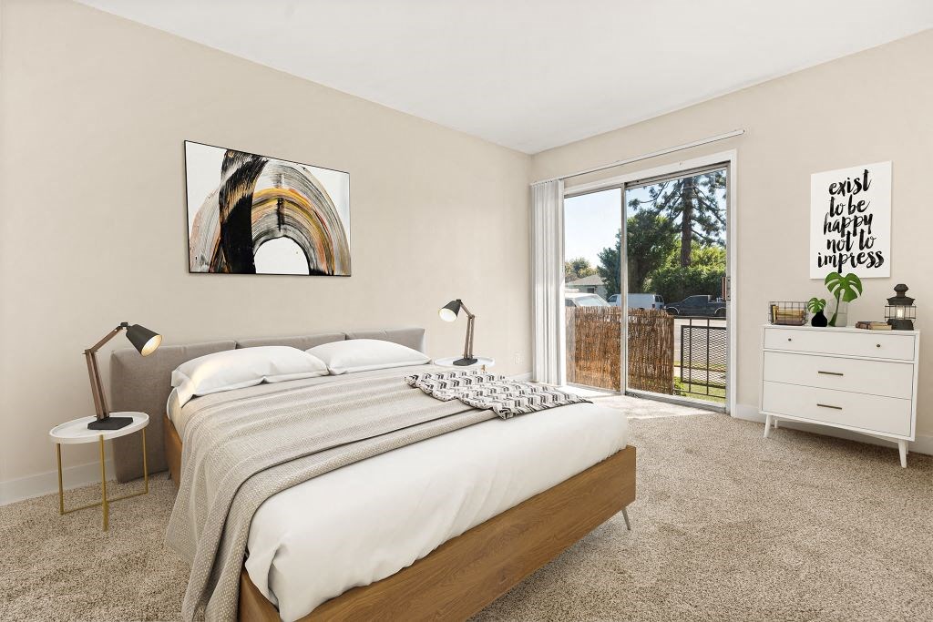 Spacious Bedroom With Berber Carpet And Sliding Glass Doors Leading To Patio/Balcony at Riverside Villas Apartments, Valley Village, CA